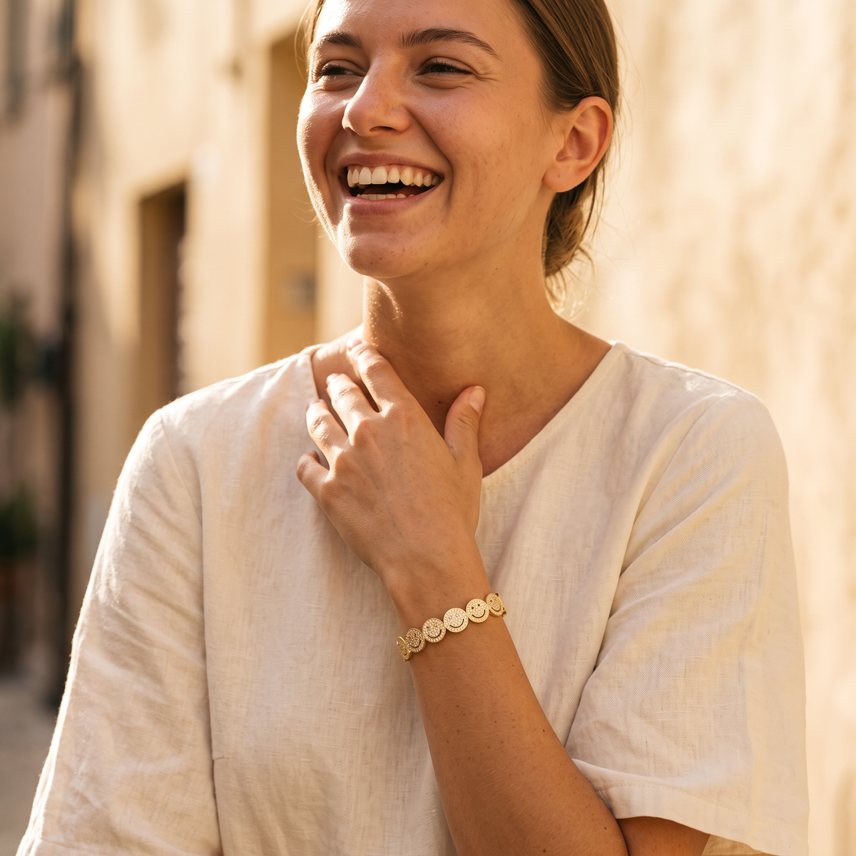 Bonheur Smile Bracelet in gold, worn outdoors in sunlight
