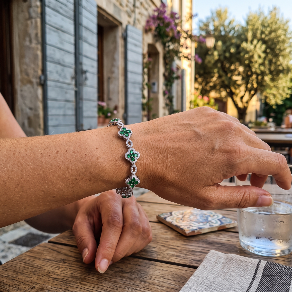 Belle Fleur Crystal Bracelet in green, worn at a cafe in the south of France